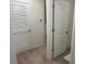 Hallway with neutral carpet and light-colored walls, featuring paneled doors at 386 Feltrim Reserve Blvd # 386, Davenport, FL 33837