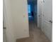 Hallway view into bedroom, featuring neutral carpets and bright lighting at 386 Feltrim Reserve Blvd # 386, Davenport, FL 33837
