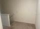 Neutral colored carpeted hallway with an electrical outlet and hand rail at 386 Feltrim Reserve Blvd # 386, Davenport, FL 33837