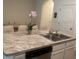 Kitchen island with granite countertop and stainless steel sink at 386 Feltrim Reserve Blvd # 386, Davenport, FL 33837