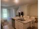 Open kitchen with granite island and stainless steel dishwasher, offering a seamless flow to living area at 386 Feltrim Reserve Blvd # 386, Davenport, FL 33837