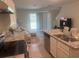 Kitchen with granite island, stainless steel dishwasher and slider to backyard at 386 Feltrim Reserve Blvd # 386, Davenport, FL 33837