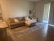 Cozy living room with comfortable seating, sliding glass doors, and modern decor at 386 Feltrim Reserve Blvd # 386, Davenport, FL 33837