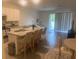 Open-concept living room with kitchen island, dining area, and comfortable seating at 386 Feltrim Reserve Blvd # 386, Davenport, FL 33837