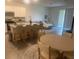 Open-concept living room with kitchen island, dining area, and comfortable seating at 386 Feltrim Reserve Blvd # 386, Davenport, FL 33837