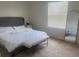 Bright main bedroom with neutral carpet, a bench at the foot of the bed and a mirror at 386 Feltrim Reserve Blvd # 386, Davenport, FL 33837