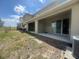 Exterior view of a covered patio and view of the grassy lawn at 386 Feltrim Reserve Blvd # 386, Davenport, FL 33837