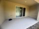 Spacious covered patio featuring a sliding glass door and expansive views of the backyard and beyond at 386 Feltrim Reserve Blvd # 386, Davenport, FL 33837