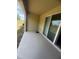 The covered patio offers serene views of the backyard and adjacent greenery through sliding glass doors at 386 Feltrim Reserve Blvd # 386, Davenport, FL 33837
