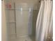 Bright walk-in shower featuring built in shelves and a white shower curtain at 386 Feltrim Reserve Blvd # 386, Davenport, FL 33837