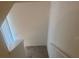 Carpeted stairway leading to the upper level of the home, with natural light from a nearby window at 386 Feltrim Reserve Blvd # 386, Davenport, FL 33837