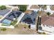 Aerial view of a home with solar panels and a screened-in pool, showcasing its energy efficiency and outdoor amenities at 404 Rio Grande Ct, Poinciana, FL 34759
