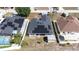 Aerial view of a house showcasing solar panels and a well-maintained backyard with privacy fencing at 404 Rio Grande Ct, Poinciana, FL 34759