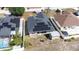 Aerial view of house, featuring solar panels on the roof and a storage shed in the backyard at 404 Rio Grande Ct, Poinciana, FL 34759