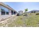 Backyard featuring green grass, backyard shed, and view of the back of the house at 404 Rio Grande Ct, Poinciana, FL 34759