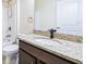 Well-lit bathroom featuring granite counters and dark cabinetry at 404 Rio Grande Ct, Poinciana, FL 34759