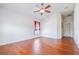 Spacious bedroom featuring wood floors, a ceiling fan, and a window providing natural light at 404 Rio Grande Ct, Poinciana, FL 34759