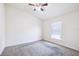 Bedroom featuring plush carpeting, ceiling fan, and window with natural light at 404 Rio Grande Ct, Poinciana, FL 34759