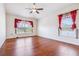 Bright bedroom featuring hardwood floors, a ceiling fan, and two windows offering ample natural light at 404 Rio Grande Ct, Poinciana, FL 34759