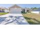 Charming single-story home featuring a wide driveway and well-maintained front lawn, with neutral stucco and white trim at 404 Rio Grande Ct, Poinciana, FL 34759