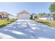 Lovely single-story home with a two-car garage, green lawn, and solar panels visible on the adjacent property at 404 Rio Grande Ct, Poinciana, FL 34759