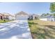 Beautiful one-story home with a wide driveway, manicured lawn, and charming architectural details at 404 Rio Grande Ct, Poinciana, FL 34759