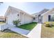 Landscaped front yard with lush grass leading to a home's entrance and garage, offering curb appeal at 404 Rio Grande Ct, Poinciana, FL 34759