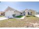 Front view of a well-kept home with a neat lawn and a two-car garage, plus an ADT security sign at 404 Rio Grande Ct, Poinciana, FL 34759
