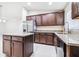Well-appointed kitchen with stainless steel refrigerator, granite countertops, and wood-finished cabinetry at 404 Rio Grande Ct, Poinciana, FL 34759
