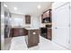 Bright kitchen with stainless steel appliances, granite countertops, and a useful island for meal preparation at 404 Rio Grande Ct, Poinciana, FL 34759