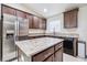 Fully equipped kitchen with stainless steel appliances, granite countertops, and island providing extra prep space at 404 Rio Grande Ct, Poinciana, FL 34759