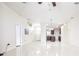 Expansive living room showcasing sleek tile flooring, neutral walls, and an open layout with kitchen access at 404 Rio Grande Ct, Poinciana, FL 34759