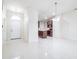 Bright, open-concept living space with a view into the kitchen and featuring sleek tile flooring at 404 Rio Grande Ct, Poinciana, FL 34759