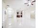 Spacious open concept living area featuring sleek tile floors with a view into the kitchen at 404 Rio Grande Ct, Poinciana, FL 34759