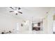 Open-concept living room featuring modern light fixtures, neutral walls, and easy access to the kitchen at 404 Rio Grande Ct, Poinciana, FL 34759