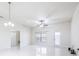 Open-concept living room with ample natural light from a large window and access to the kitchen and other living areas at 404 Rio Grande Ct, Poinciana, FL 34759