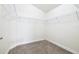 Organized walk-in closet featuring carpeted floors and wire shelving for ample storage at 404 Rio Grande Ct, Poinciana, FL 34759
