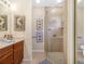 Bathroom featuring a glass-enclosed shower and wooden vanity with elegant decor at 4148 Dunmore Dr, Lake Wales, FL 33859