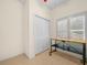 Bright bedroom featuring a work station, closet, and a window for natural light at 4148 Dunmore Dr, Lake Wales, FL 33859