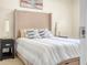 Comfortable bedroom featuring a stylish bed with decorative pillows and coordinating nightstands at 4148 Dunmore Dr, Lake Wales, FL 33859