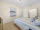 Bright bedroom showcasing a comfortable bed, soft carpet, and ample closet space at 4148 Dunmore Dr, Lake Wales, FL 33859