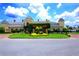 Elegant clubhouse with a covered entrance, beautiful landscaping, and ample parking at 4148 Dunmore Dr, Lake Wales, FL 33859