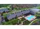 Aerial view of the community clubhouse and pool with golf course and neighborhood in background at 4148 Dunmore Dr, Lake Wales, FL 33859