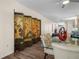 Bright dining room with decorative folding screen, ceiling fan, glass table, and wood floor at 4148 Dunmore Dr, Lake Wales, FL 33859