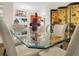 Bright dining area with glass table, modern art, and artistic decorative folding screen at 4148 Dunmore Dr, Lake Wales, FL 33859