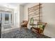 Inviting foyer with bamboo art piece, chairs, side table, and area rug creating a warm, stylish entrance at 4148 Dunmore Dr, Lake Wales, FL 33859