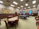 Spacious game room features billiard tables and poker tables for entertaining residents and guests at 4148 Dunmore Dr, Lake Wales, FL 33859