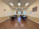Bright game room with round tables and chairs, perfect for residents to socialize and enjoy activities at 4148 Dunmore Dr, Lake Wales, FL 33859
