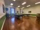 Bright game room featuring two billiard tables, wood floors, and tasteful decor for residents' enjoyment at 4148 Dunmore Dr, Lake Wales, FL 33859