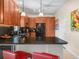Charming kitchen with granite countertops, cherry cabinets, and stainless steel appliances at 4148 Dunmore Dr, Lake Wales, FL 33859